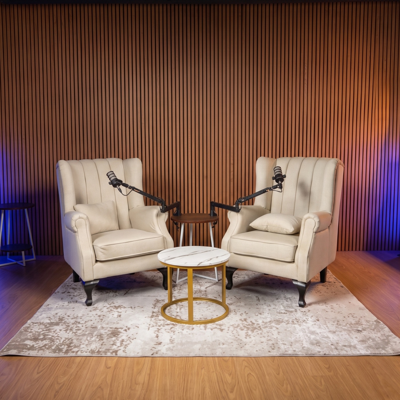The Growth Story MY recording set — two armchairs with microphones in front of a slatted wood wall